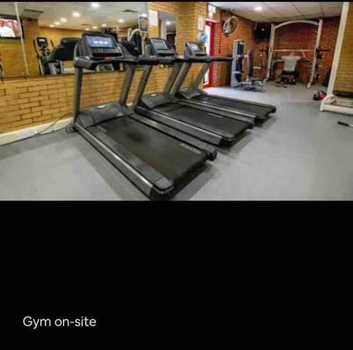 a gym with a row of equipment in a room at Pinto Holiday Home Oakdene Forest Park Passes Inc! in Ringwood