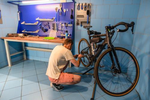 a man is working on a bike in a garage at Kormoran Medispa in Rowy