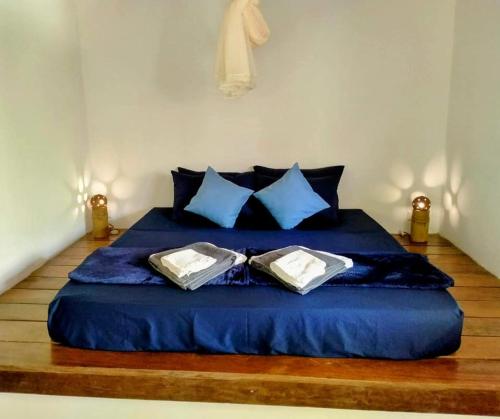 a blue bed with two pillows on top of it at Rainbow Lodge in Koh Kong