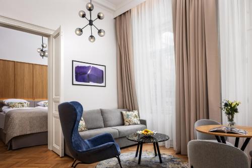 a living room with a couch and a bed at R16 Residences Prague in Prague