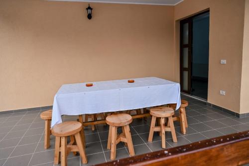 a table with chairs and a white table cloth on it at Casa Abrudan in Scrind-Frăsinet