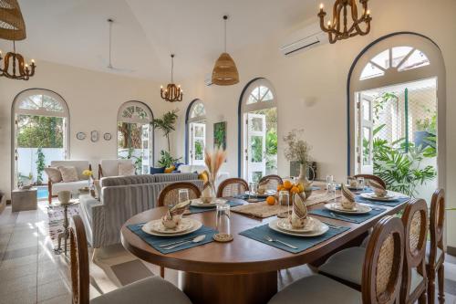 a dining room with a table and chairs at LohonoStays Aurelia Villa D in Vagator