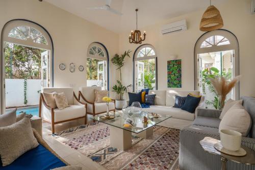 a living room with a couch and a table at LohonoStays Aurelia Villa D in Vagator