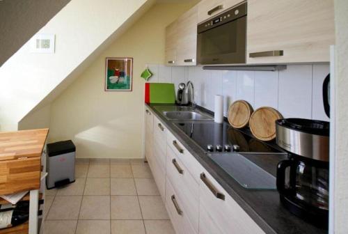 a kitchen with a sink and a counter top at Strandschloesschen-Haus-II-WE-21-9820 in Kühlungsborn