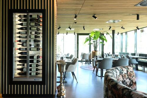 a dining room filled with lots of wine racks at Wapen van Hengelo Residence Suites - digital key by SMS and email in Hengelo