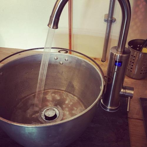 a metal bowl with a stream of water in a sink at Matlock Glamping Rooms in Matlock