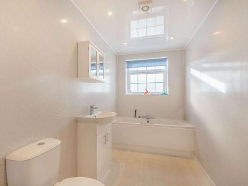 a white bathroom with a toilet and a sink at 2 Bed in Ayr 90039 in Ayr