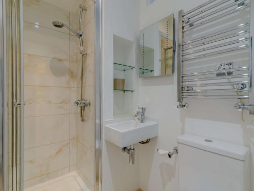 a bathroom with a shower and a sink and a toilet at 3 Bed in Harrogate 90032 in Harrogate
