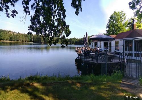 a house with a boat on a lake at Zwaan7, Top Locatie! Top Deal! in Rekem