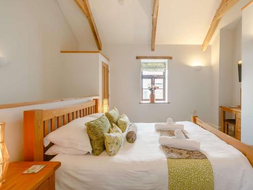 a bedroom with a large white bed and a window at 1 Bed in Newquay 89942 in Mawgan Porth
