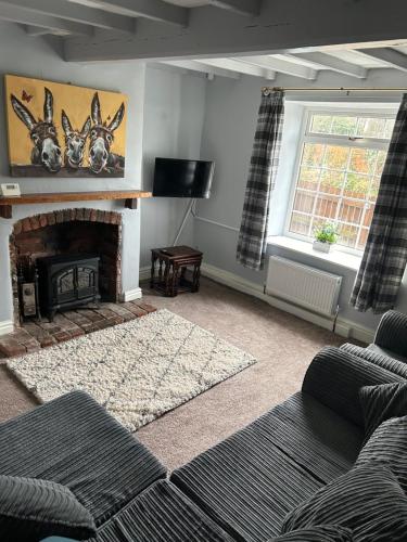 ein Wohnzimmer mit einem Kamin mit zwei Hirschköpfen an der Wand in der Unterkunft Onchan House, Beal in Knottingly