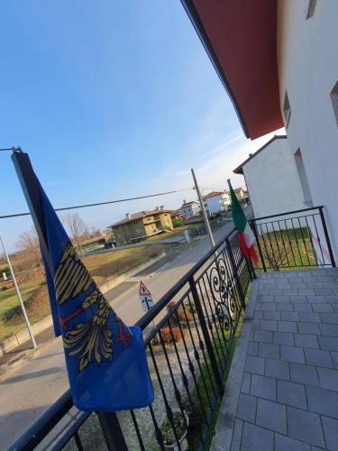 a flag hanging on a fence next to a street at Casa Ortensia in Grions