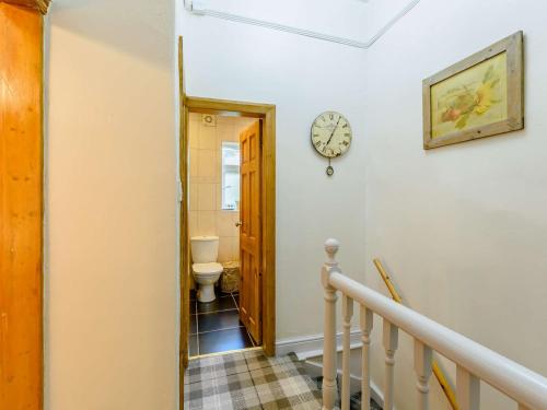a hallway with a toilet and a clock on the wall at 1 bed property in Haworth 89955 in Oxenhope