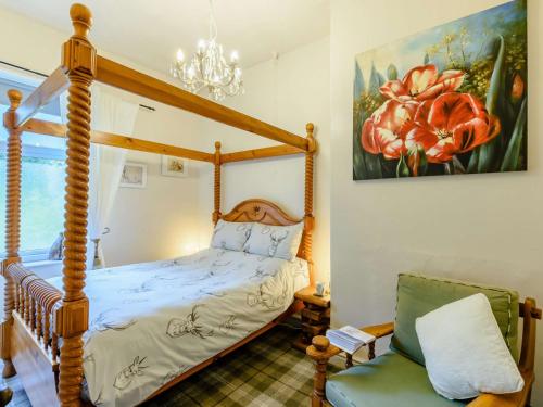 a bedroom with a four poster bed and a chair at 1 bed property in Haworth 89955 in Oxenhope