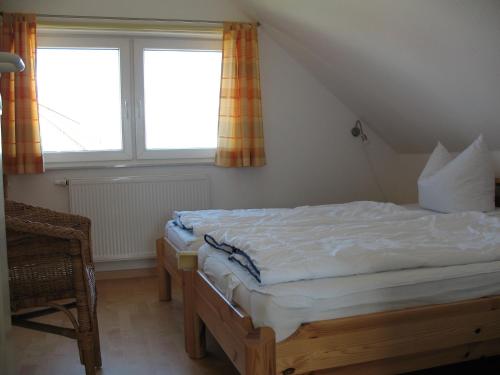 a bedroom with a bed and a large window at Ferienhaus Seeblick 39 in Holnishof