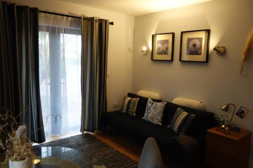 a living room with a couch and a window at Stunning guest house in Frenchay in Bristol