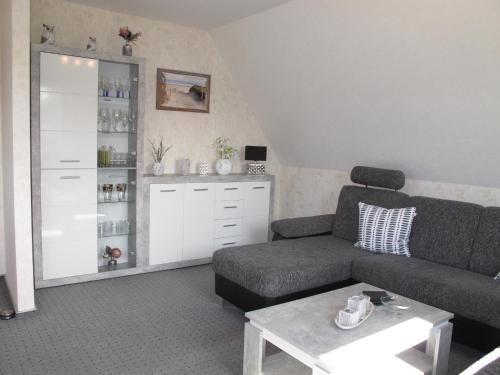 a living room with a couch and a coffee table at Ferienwohnung ERNA HORS110 in Wangerland