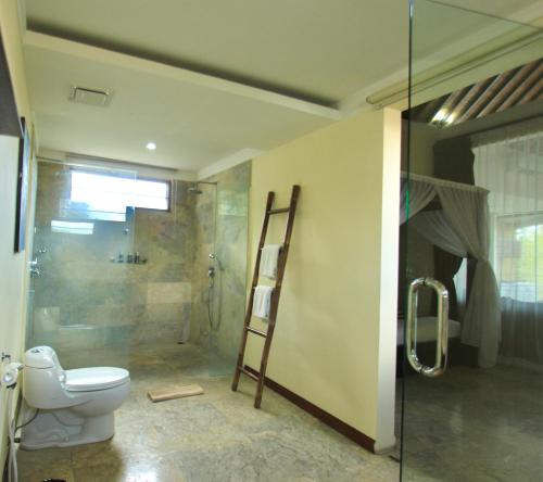 a bathroom with a toilet and a glass shower at O Villas Seminyak - 2026 Earlybirds ON SALE! in Seminyak