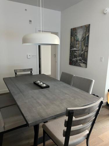 a dining room table with chairs and a light fixture at Condo in Quebec City