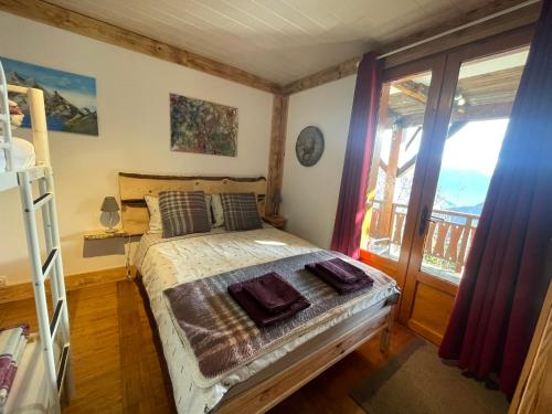 Schlafzimmer mit einem Bett und einem Fenster in der Unterkunft Chalet Le Doux Si, Large Self-Contained Apartment, 2km from Doucy-Combelouvière and close to Valmorel in La Lechere