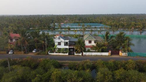 an aerial view of a house next to a body of water at Karma Homestay in Munroe Island