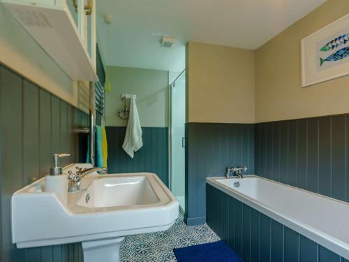 a bathroom with a sink and a bath tub at 3 Bed in Blairgowrie 90111 in Blairgowrie