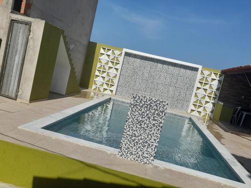 a swimming pool on the side of a house at Pousada Progresso in Parnaíba