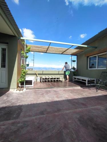 a man standing on the patio of a house at ENCUENTRO LA ÑATA in Amaichá del Valle