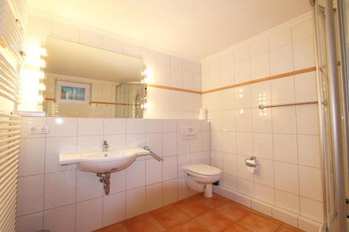 a bathroom with a sink and a toilet at Dünental 6b in Wenningstedt