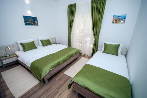 a bedroom with two beds with green sheets at Villa Manuela near Medulin with private pool only 500 meters from sea in Banjole