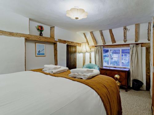 a bedroom with a large bed and a window at 2 bed property in Bury St Edmunds 90090 in Rattlesden