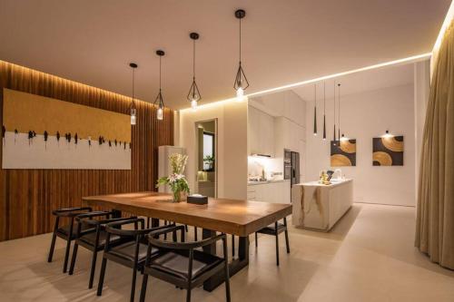 a kitchen and dining room with a wooden table and chairs at NEW Luxury 3BR, Jacuzzi Rooftop Rice Field, Staff in Legian