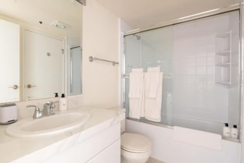a white bathroom with a sink and a toilet at South Beach 1br across the street from SF bay SFO-1661 in San Francisco