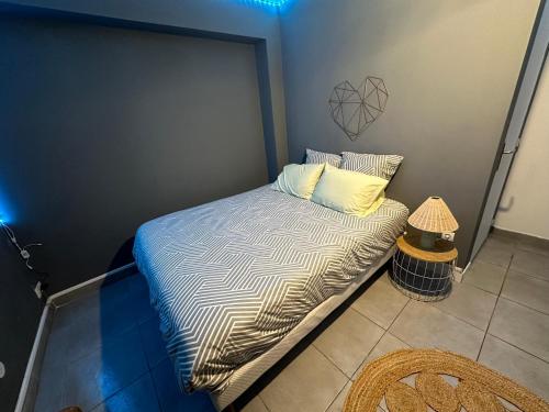 a small bed in a small room with at Guest Room Deluxe Proche Paris, Roissy CDG & Village Olympique in Persan
