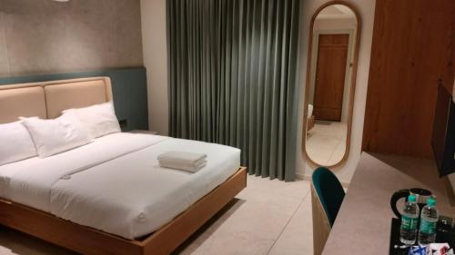 a bedroom with a bed and a large mirror at Livi Suites - Premium 1 BHK Serviced Apartments in Bangalore