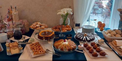 a table filled with different types of pastries and desserts at Hotel Villa Bernt in Grado