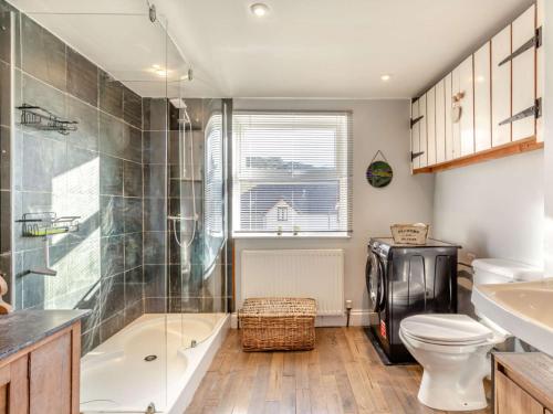 a bathroom with a toilet and a tub and a sink at 4 Bed in Woolacombe 90224 in Mortehoe