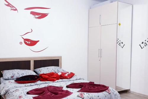 a bedroom with a bed with red pillows on it at Cazare Centru Brasov in Braşov