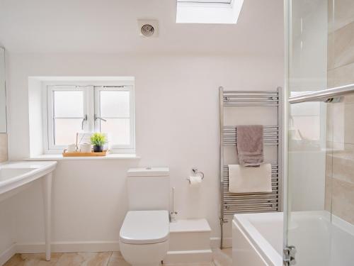 a white bathroom with a toilet and a shower at 4 Bed in Newport 90251 in Newport