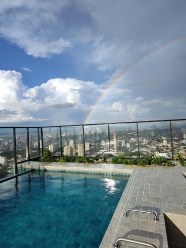 a pool with a rainbow in the sky at 2403 apartamento Setor Oeste gyn in Goiânia