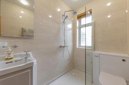 a bathroom with a shower and a sink at Sea Mist in Southwold