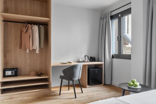 a bedroom with a desk and a chair in a room at Azur Hotel Volos in Volos