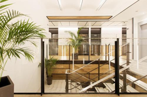 a staircase in a room with potted plants at Green House Hotel in Barcelona