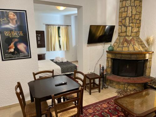 a living room with a living room with a fireplace at Muntenia Inn Apartments and Suites in Kalavrita