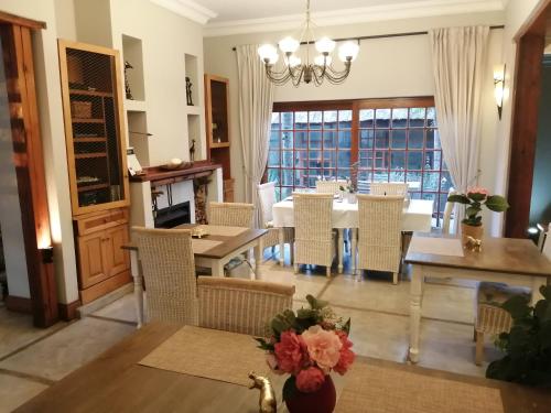 a dining room with a table and chairs at Ikamu's lodge in Germiston