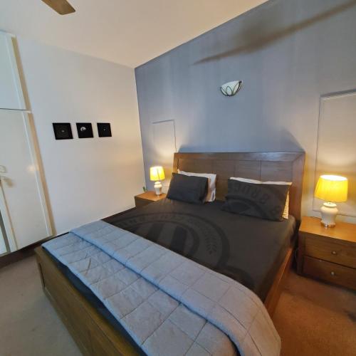 伊斯蘭堡的住宿－Private Suite F-10 Islamabad，一间卧室配有一张大床和两张台灯。