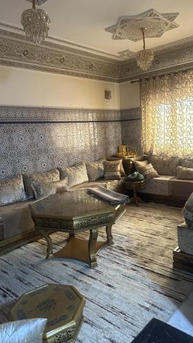 a living room with a couch and a table at Dikra apparemment in Fez