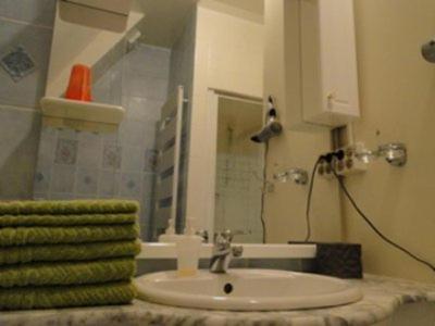 a bathroom with a sink and a green towel at B&B La Villa Zarin in Brussels