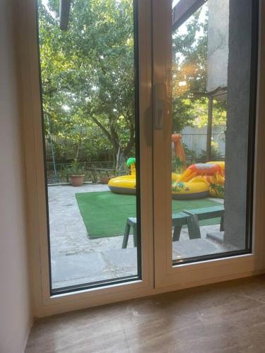 a sliding glass door with a view of a playground at Милое желье для пар рядом с станцией С. Давид in Yerevan