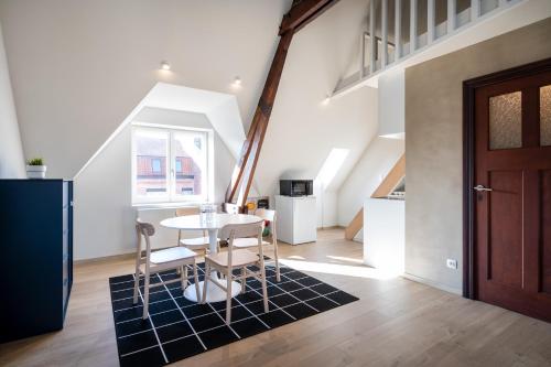 a kitchen and dining room with a table and chairs at General Sixty-Seven by Romy&Travis in Bruges